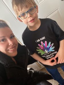 Woman with young boy in glasses