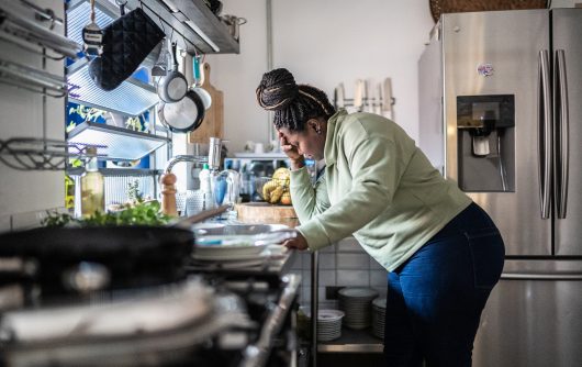 Sad mid adult woman in the kitchen at home