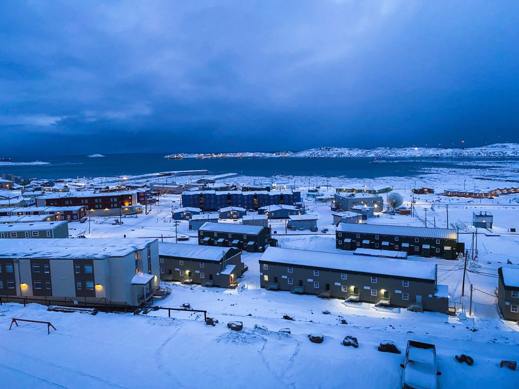 Aerial view of Hamlet, an Arctic town, showcasing its unique landscape and charming architecture.