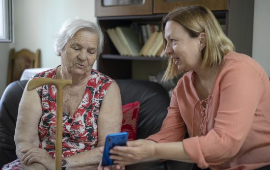 Daughter introducing her mother to the new technology