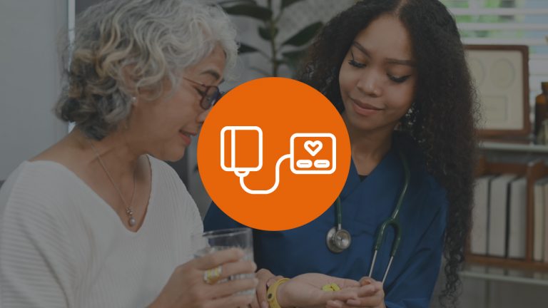 A nurse and an elderly woman sitting on a couch