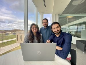 A group of three students sitting and posing for a group photo