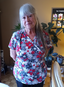 Lady in nursing uniform smiling at camera