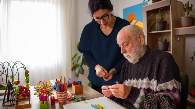 Dementia Care - Caregiver assisting senior man