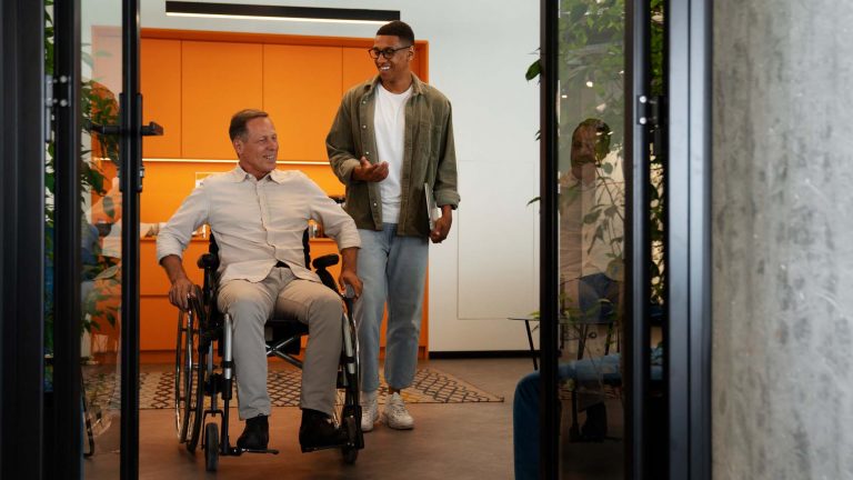 Man in a wheelchair talking to another man