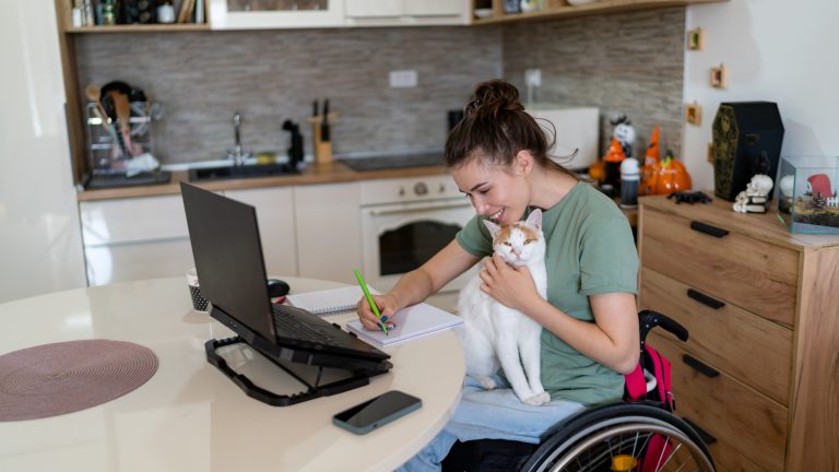woman in wheelchair working on laptop