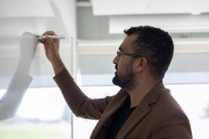 Hamza Khan, spécialiste de l’apprentissage et du développement, écrivant sur un tableau blanc