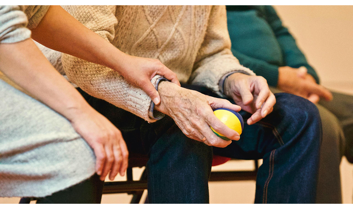 Elderly people sitting together, holding hands