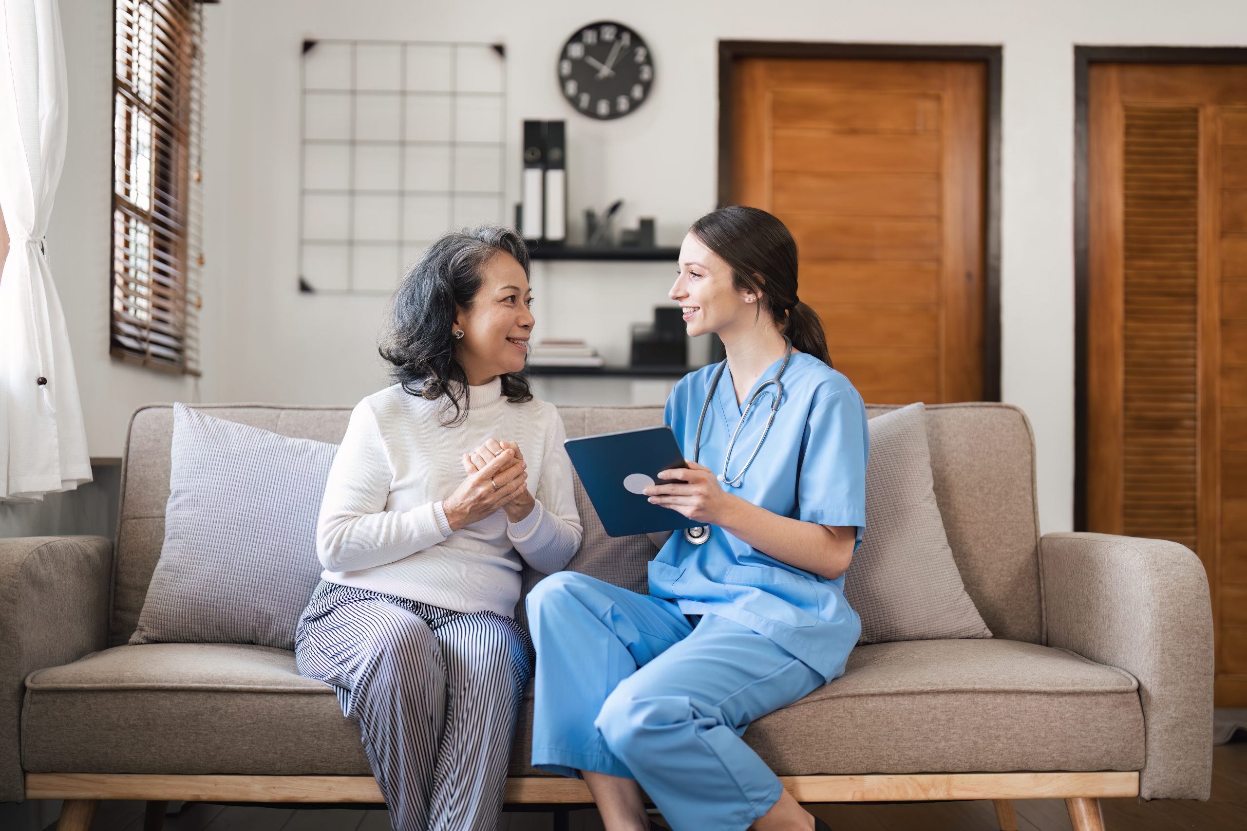 Healthcare worker talking with a patient on a couch