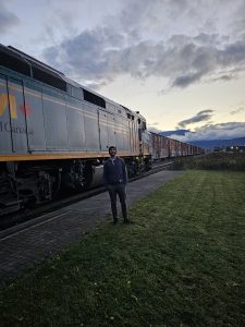 Man standing infront of train tracks