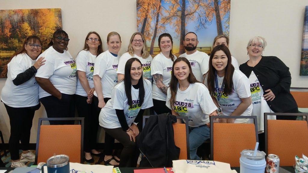Bayshore Home Health staff members wearing Best Practice Champion T-shirts at a workshop.