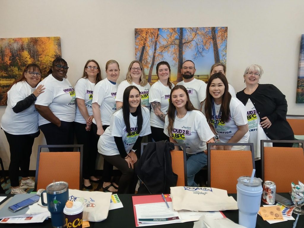 Bayshore Home Health staff members wearing Best Practice Champion T-shirts at a workshop.