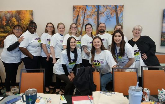 Bayshore Home Health staff members wearing Best Practice Champion T-shirts at a workshop.